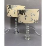 Two perspex and chromium plated table lamps with oval apricot shades decorated with silver leafage