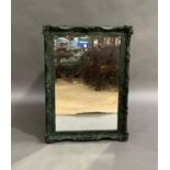 A Victorian style mirror, the frame painted in 'army camouflage' 110cm by 78cm