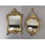 Two gilt metal framed wall mirrors, oval with shell cresting cherub and c-scroll frame with