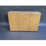 A modern beech side cabinet fitted with four central drawers flanked by pair of cupboards, 136cm