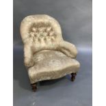 A Victorian buttoned nursing chair with serpentine stuffed over seat on turned legs