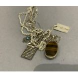 A collection of silver necklaces and pendants variously set with tiger eye and simulated