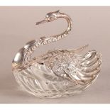 A .925 SILVER AND CUT GLASS 'SWAN' BON BON DISH, floral embossed neck and pierced wings, 16.5cm long