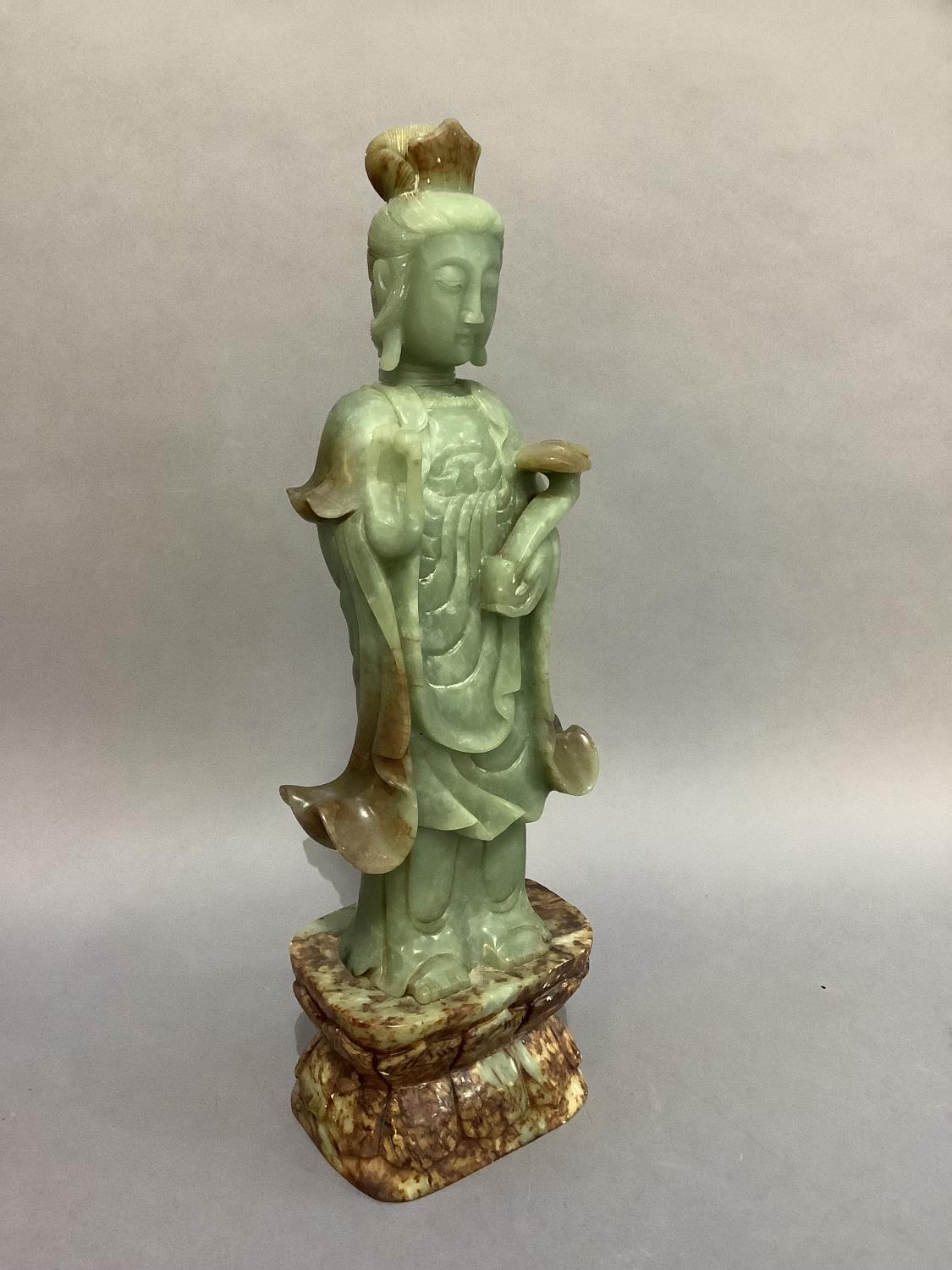 A soapstone figure of Guanyin standing on a lappet carved, waisted and rounded rectangular base, - Image 2 of 2