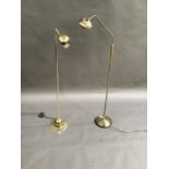 Two modern brass and brushed brass adjustable reading lights