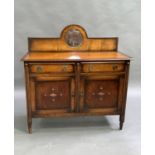 An oak sideboard with arched back set with central bevelled circular mirror, applied bead mouldings,
