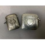 A late Victorian silver foliate engraved vesta case, the front with initialled shield shaped