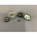 An 800 std silver pill box with domed lid and flowerhead finial, the body engraved with a band of