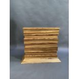 A modern striped hardwood veneered pedestal T.V stand of rectangular stepped panelled form on