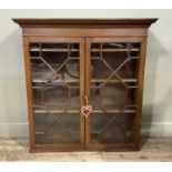 A George III style oak bookcase top with flared cornice, shallow frieze, enclosed by a pair of