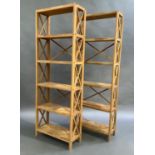 A pair of oak laminate fixed open book shelves with X-frame sides and X-frame backs to two sections,