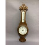 An Edwardian oak cased wheel barometer with thermometer by R.T Hodgson, Harrogate