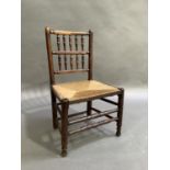 A 19th century elm child's spindle back chair with pair of horizontal spindle rails, rush seat on