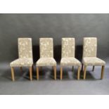 A set of four oak framed dining chairs each upholstered in oatmeal coloured damask fabric