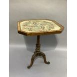 A tripod table, the octagonal top with broad cross banded border and reel moulding, enclosing a