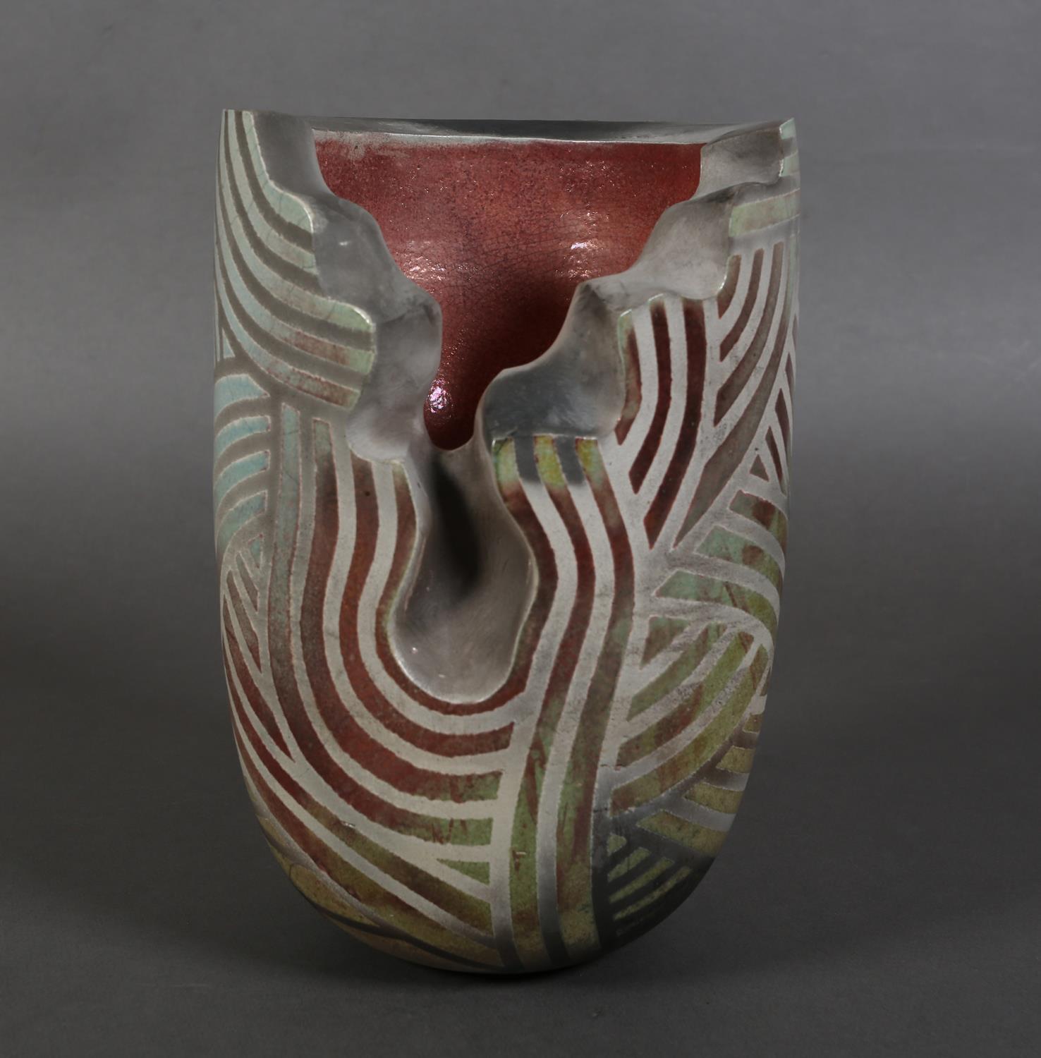 Paul Muchan (b.1948), an earthenware vase, cut away section to the body, matt grey linear designs on