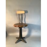 A Singer cast iron revolving machinist's chair with circular seat and spring hinged back, 78cm