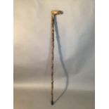 An interesting briar wood walking stick, the handle terminal carved as an upturned foot, 82cm high