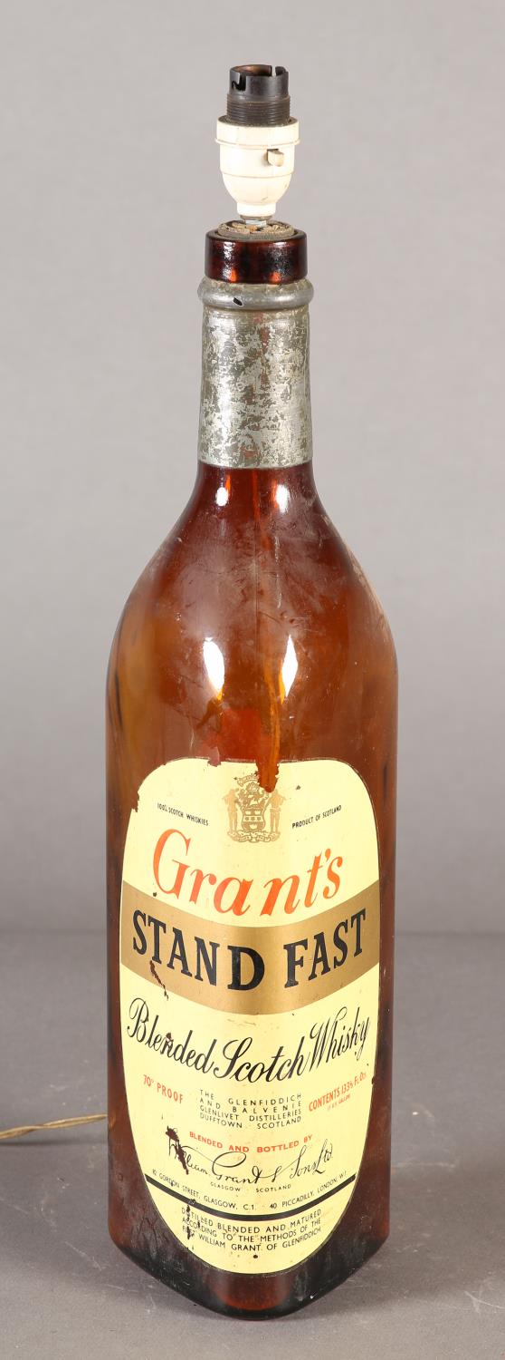 A large Grant's Stand Fast Whisky bottle lamp base of triangular form in brown glass with original