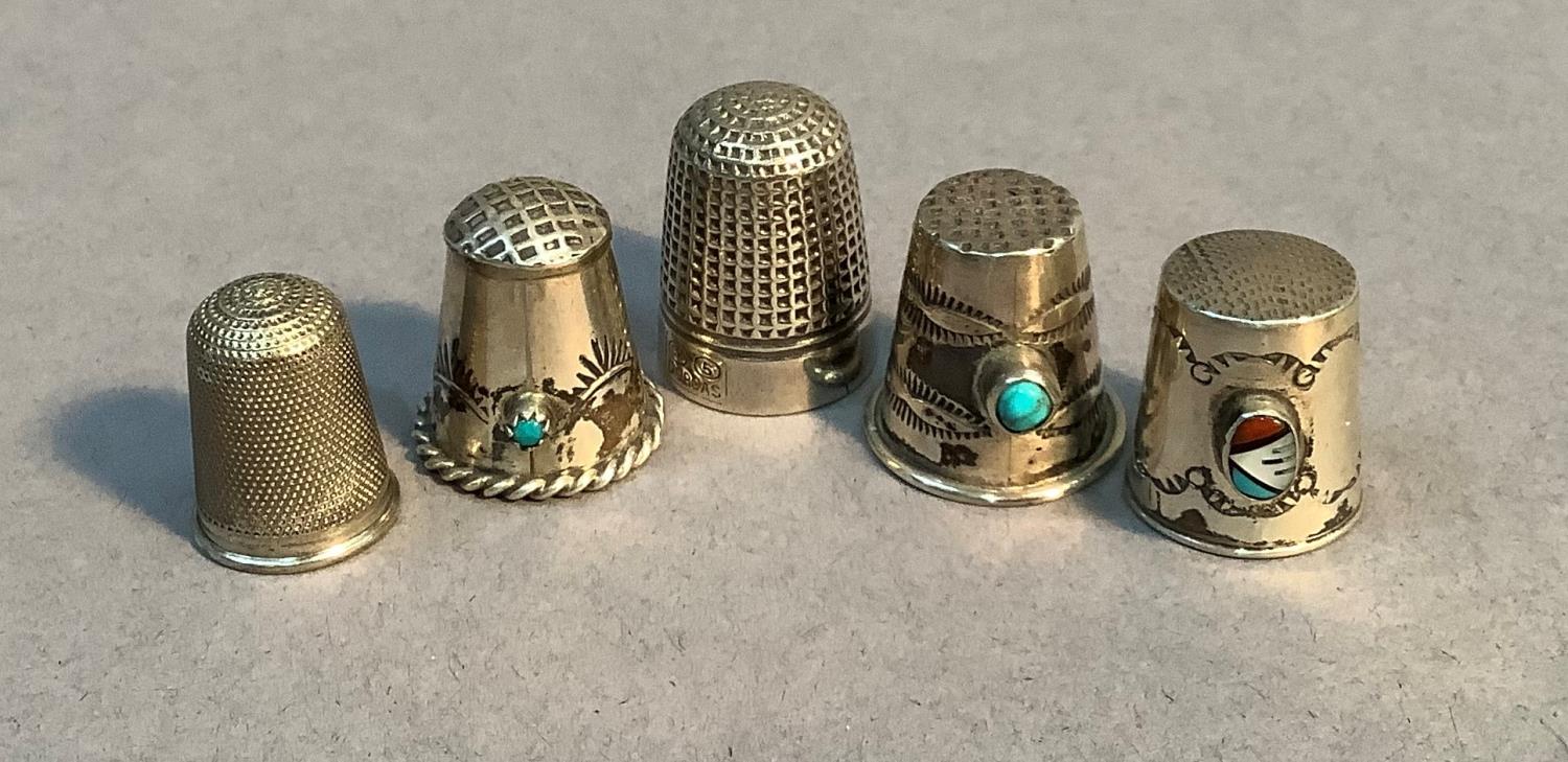 Three white metal thimbles, two set turquoise cabochon, the other with oval cabochon, a Dorcas No