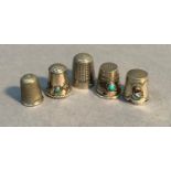 Three white metal thimbles, two set turquoise cabochon, the other with oval cabochon, a Dorcas No