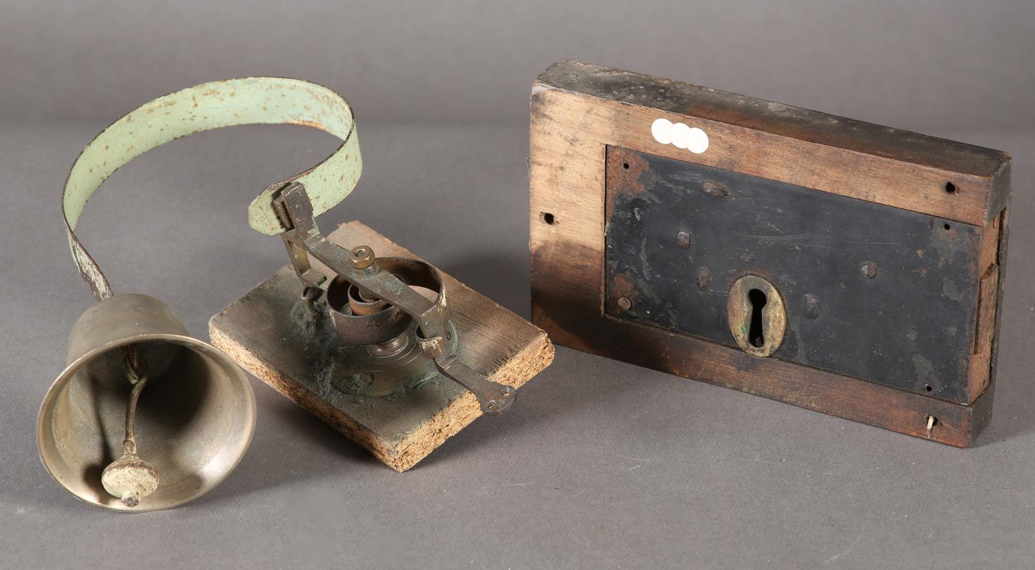 An early 20th century shop door bell and a door lock