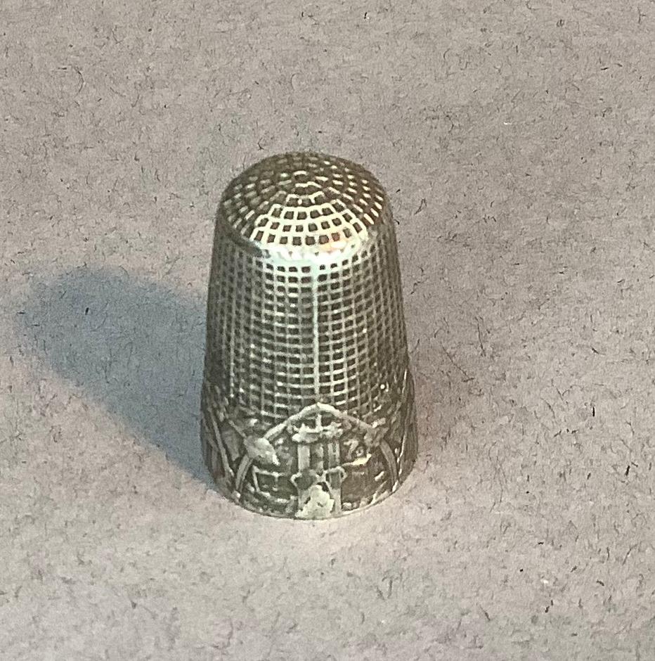 Of sewing interest - a Dutch silver fable thimble embossed with monkeys sitting beside a