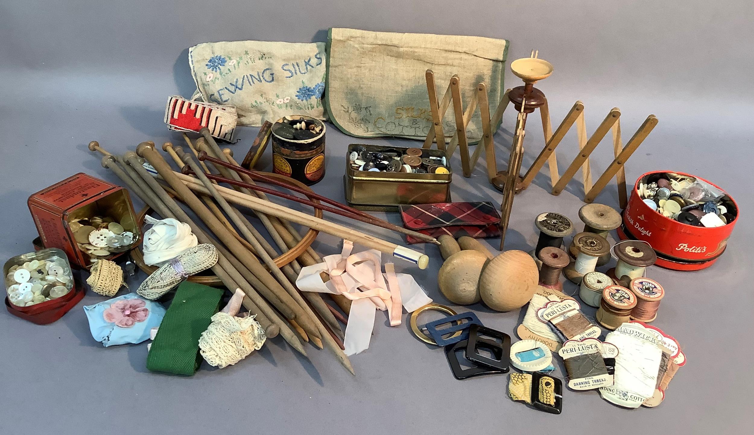 A box of vintage haberdashery including buttons, threads, darning mushrooms and a cat's cradle and