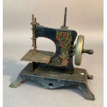 A Victorian black japanned toy sewing machine, 19cm high