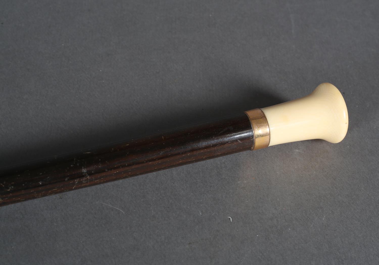 A rosewood tapered walking stick with gold pated collar and ivory pommel, brass ferrule, 92cm high - Image 3 of 3