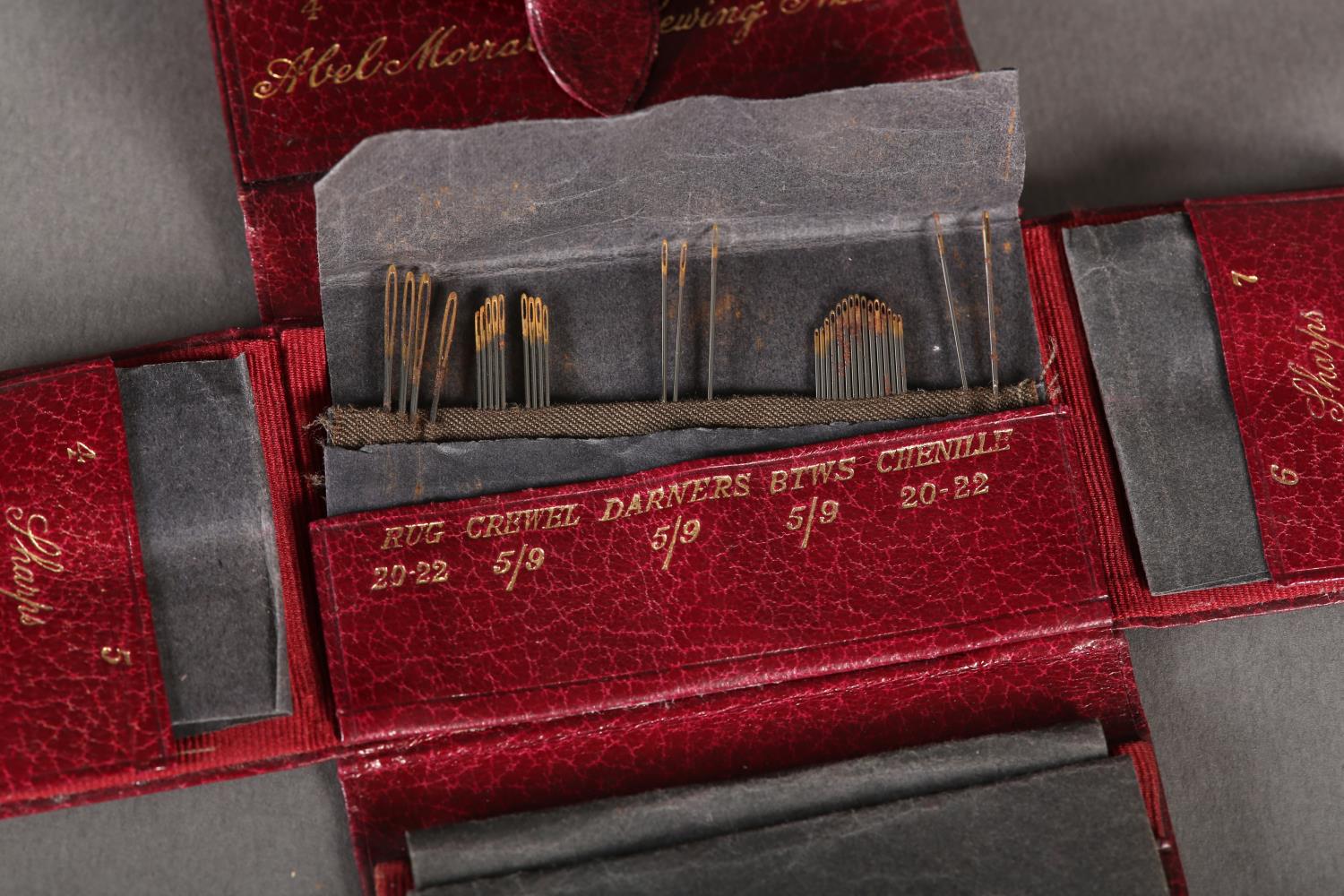 An Edwardian maroon leather needle wallet stamped in gilt Abel Morrall's Sewing Needles,