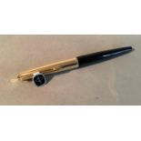 An American Parker fountain pen in black with gold plated cap, gold nib, 13.5cm long