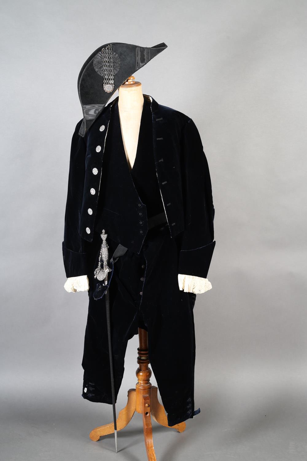 A court suit of dark blue velvet comprising coat with cream lace cuffs, breeches, waistcoat and