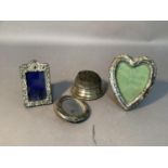 Three early 20th century photograph frames of circular, rectangular and heartshape together with a