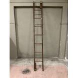A reproduction brass capped and closed studded folding library ladder, cased in brown leather, 262cm