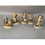 Five Hummel figures including Apple Tree Girl and Boy, Merry Wanderer and others