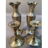 A pair of silver candlesticks on circular spreading bases, 11cm high, Birmingham 1917 together