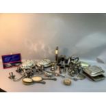 A collection of silver plated ware including candelabra, table lamp, entrée dishes, goblets, mugs,