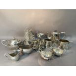 Two silver plated tea services of half reeded and engraved decoration, a four bottle and EPNS