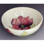 A Moorcroft Magnolia bowl painted and tub lined in pink, mauve, green and brown on a cream ground,