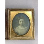 A 19th century daguerreotype, half portrait of a young girl, her hair in ringlets