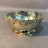 A white metal bowl (tests as silver) cast with grapevine border on beaded foot rim, 13cm diameter