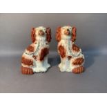 A pair of Staffordshire spaniels sponged in iron red, 23cm high