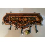 A walnut and marquetry wall panel key holder hung with seven 18th/19th century keys and a