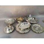 A collection of silver plated ware including tureen holders, trays, cake basket, muffin dish etc