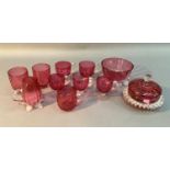 A collection of cranberry glass including five custard cups, pair of beakers, cream jug, sugar bowl,
