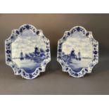 A pair of continental porcelain wall plaques of shaped rectangular form, painted with windmills
