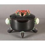 A black glaze earthenware seafood bowl and cover with crab finial, oyster shell handles and four