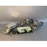 A four piece silver plated tea service with ebonised handles and finials, sauceboat, oval tureen and
