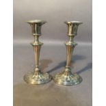 A pair of silver candlesticks of neo-classical design, oval, 17cm high, Birmingham 1916